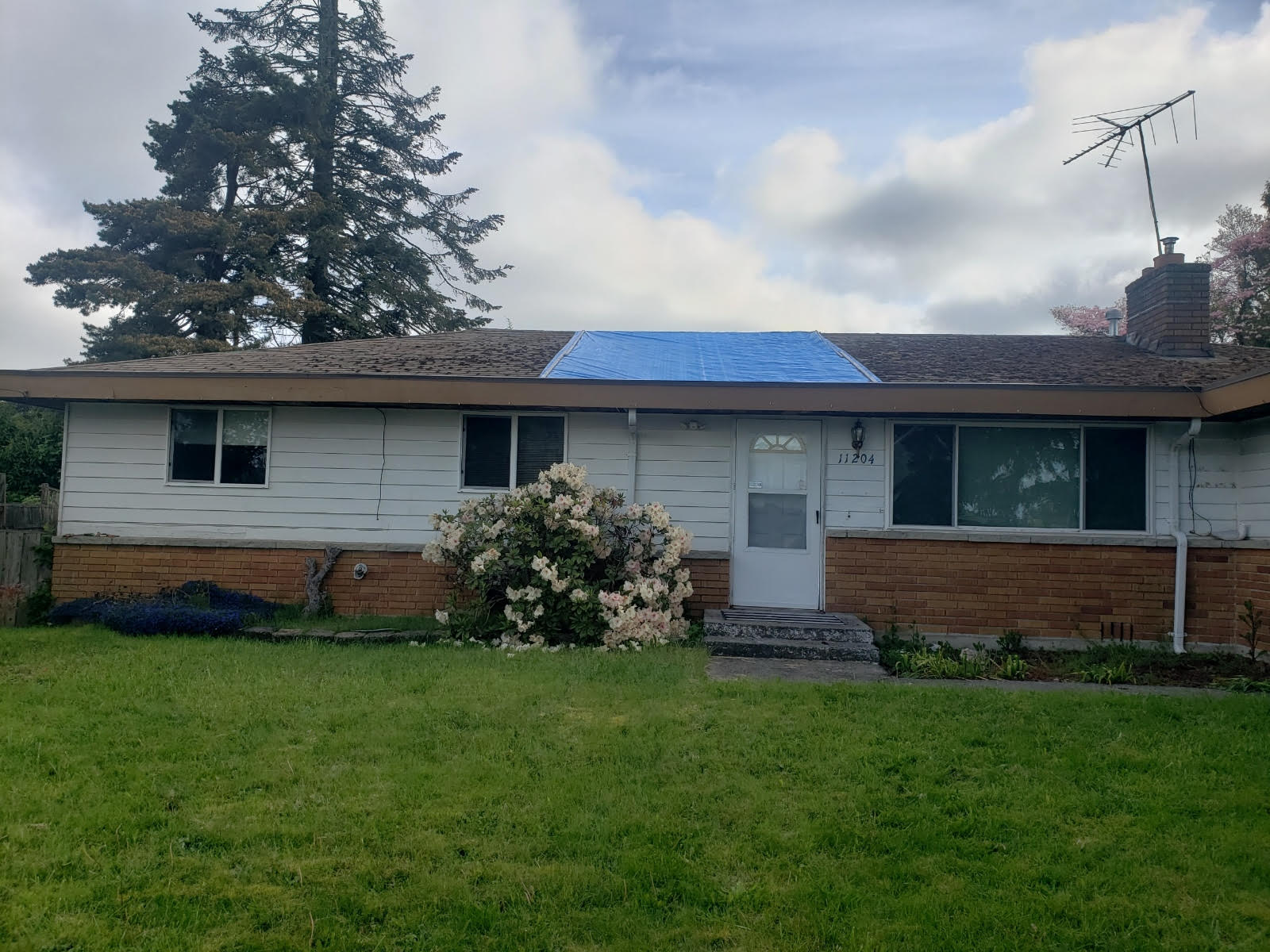 home with a damaged roof in Puget Sound, WA