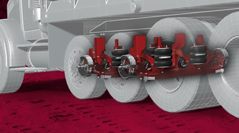 A close up of a truck 's tires on a red carpet.