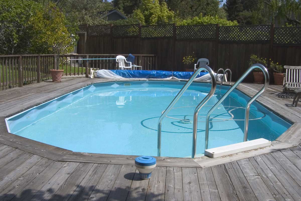Swimming Pool Surrounded by Deck — Pool Installation in Macquarie Fields, NSW