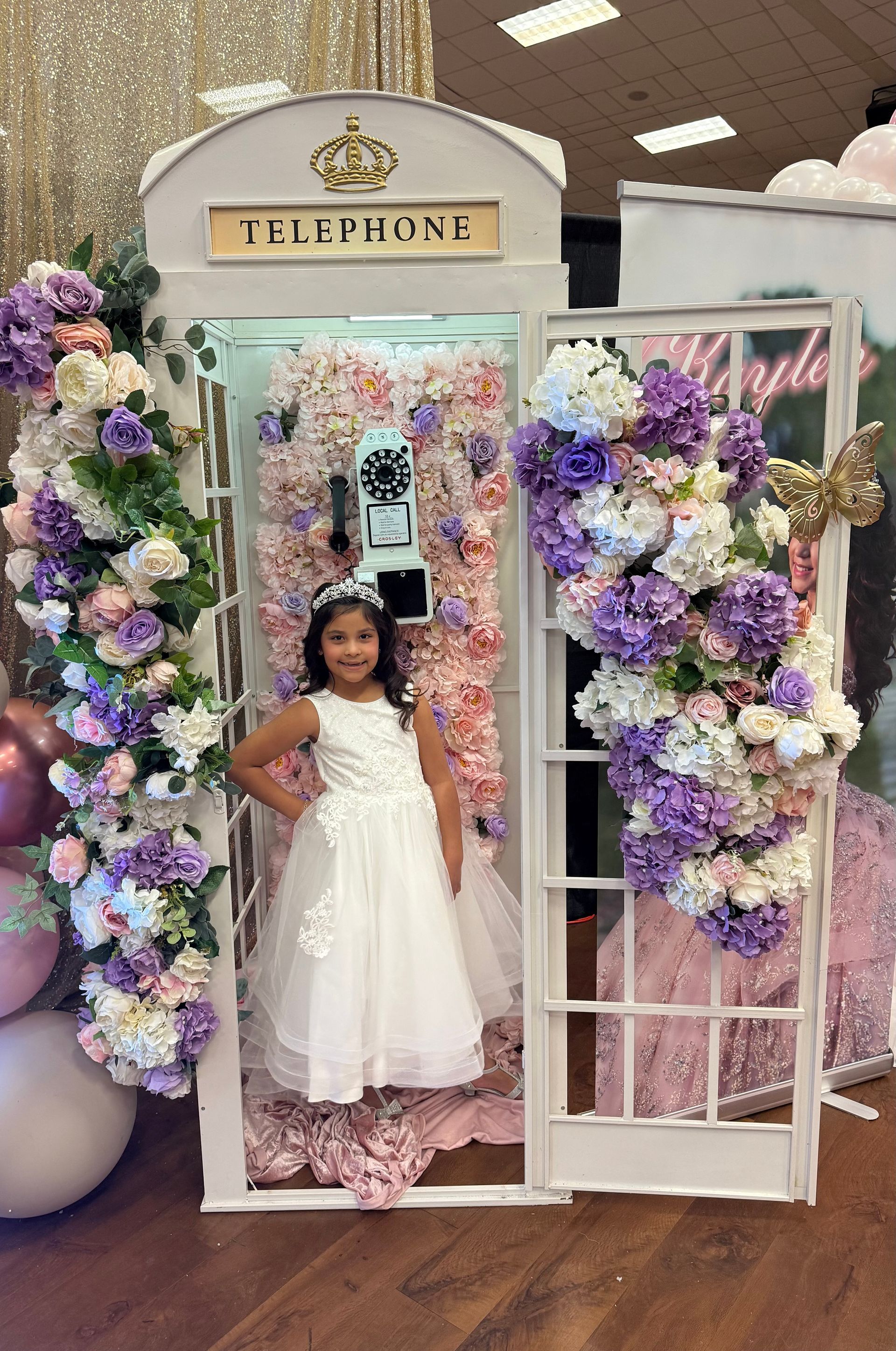The flower girl is wearing a flower crown and holding a bouquet of flowers.
