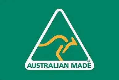 Interior of a Camper With a Bed, Small Kitchen, and a Large Window — Coastal Mattress' Direct in South Nowra, NSW