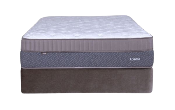 A mattress on a bed frame, white and grey, indoors.