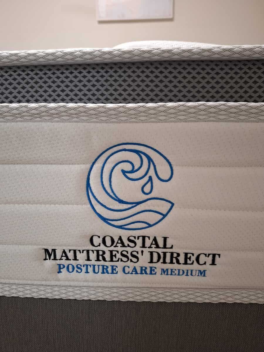 Coastal Mattress Direct mattress with a wave logo and
