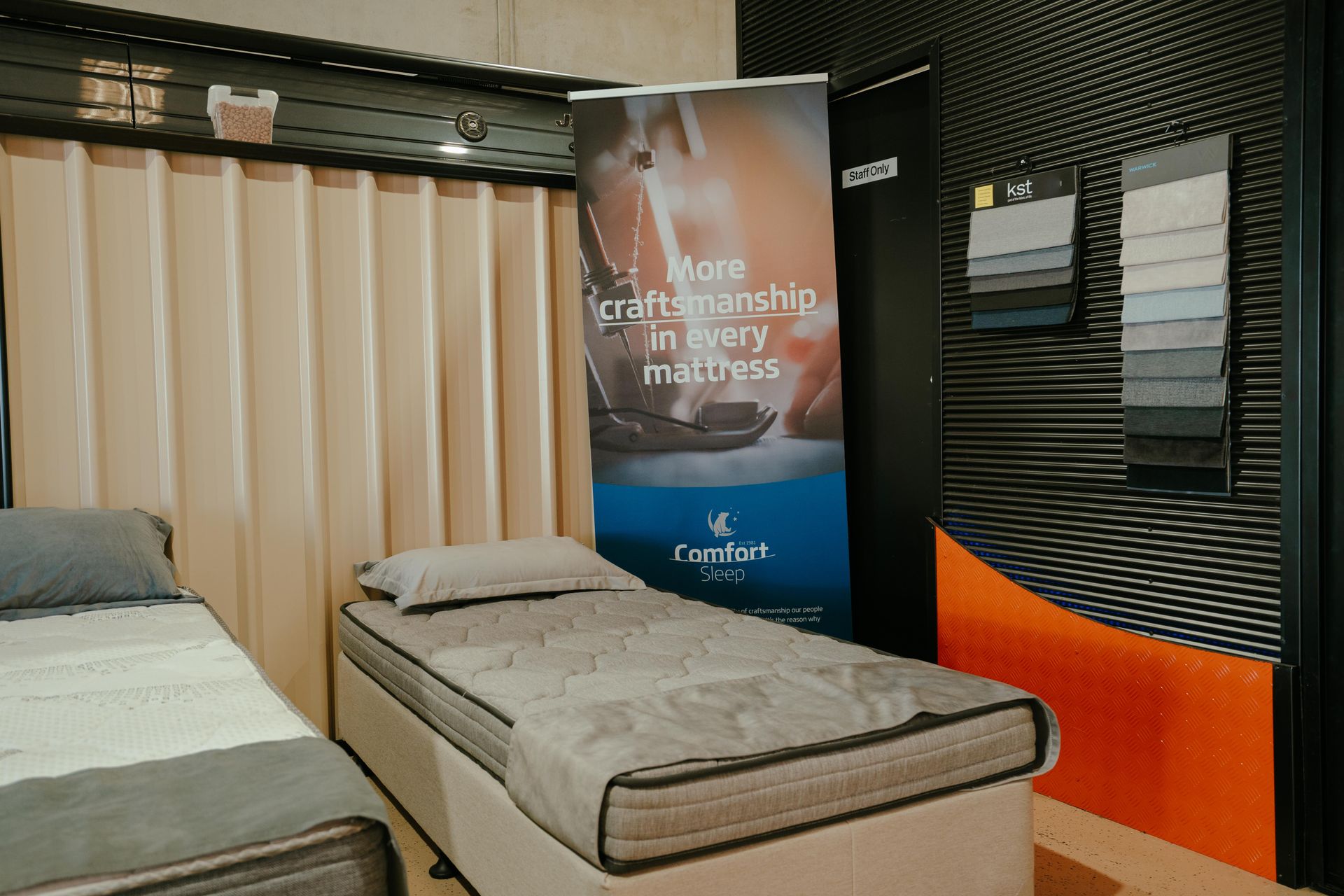 Two beds in a showroom with a banner reading
