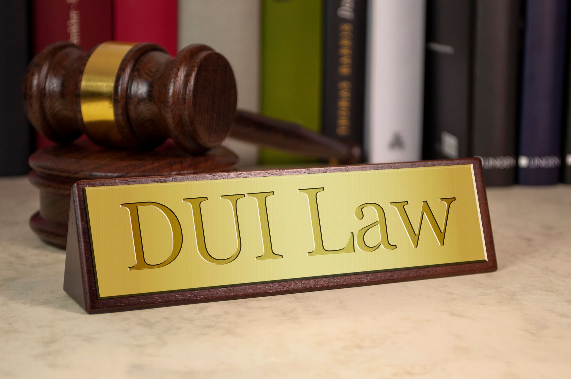 Golden sign with DUI law text and wooden gavel.