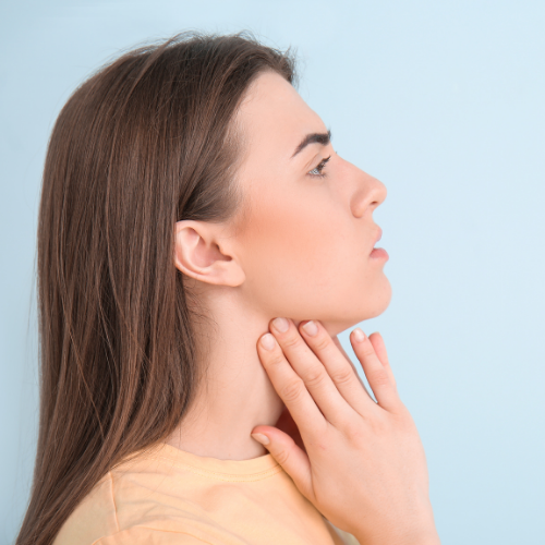 woman holding jaw in pain | get TMJ therapy in Coraopolis PA