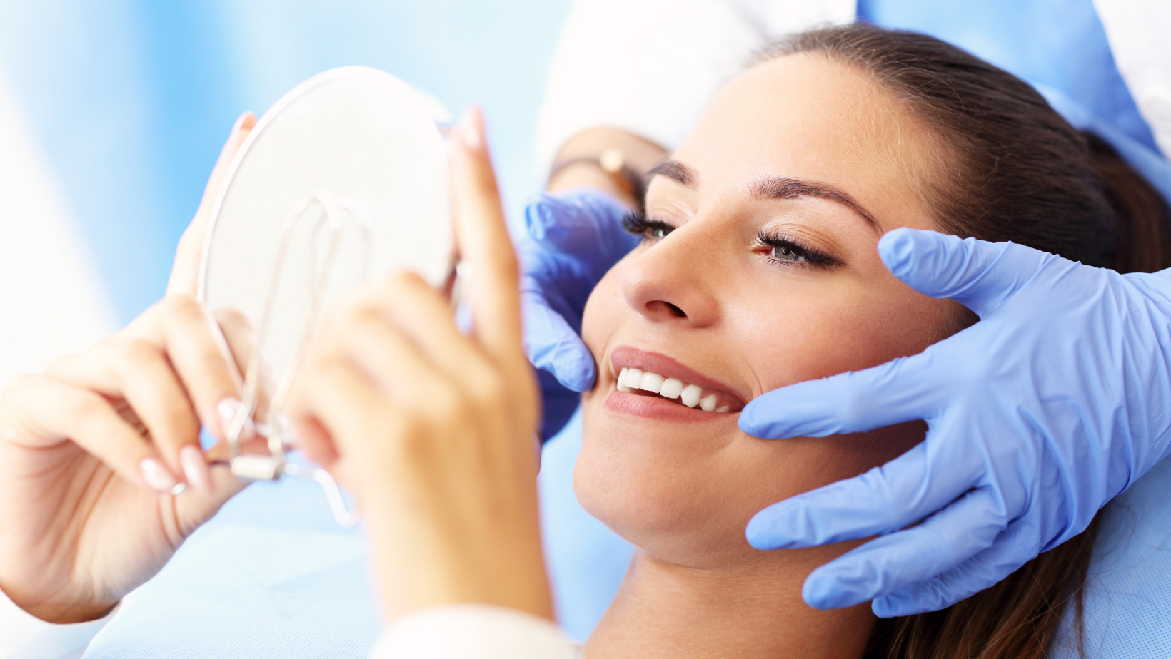 Woman at dentist smiling in mirror | gum disease therapy in Coraopolis, PA