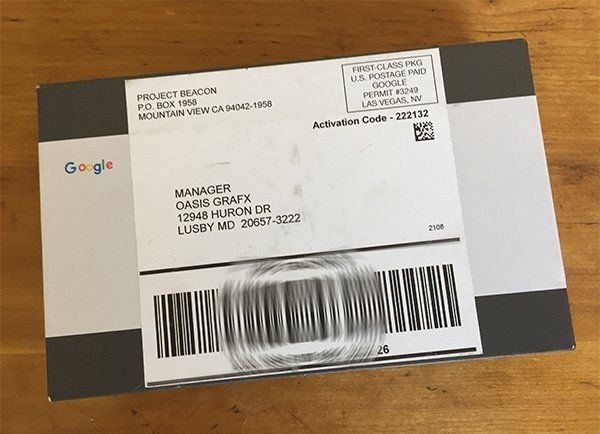 A package from google is sitting on a wooden table