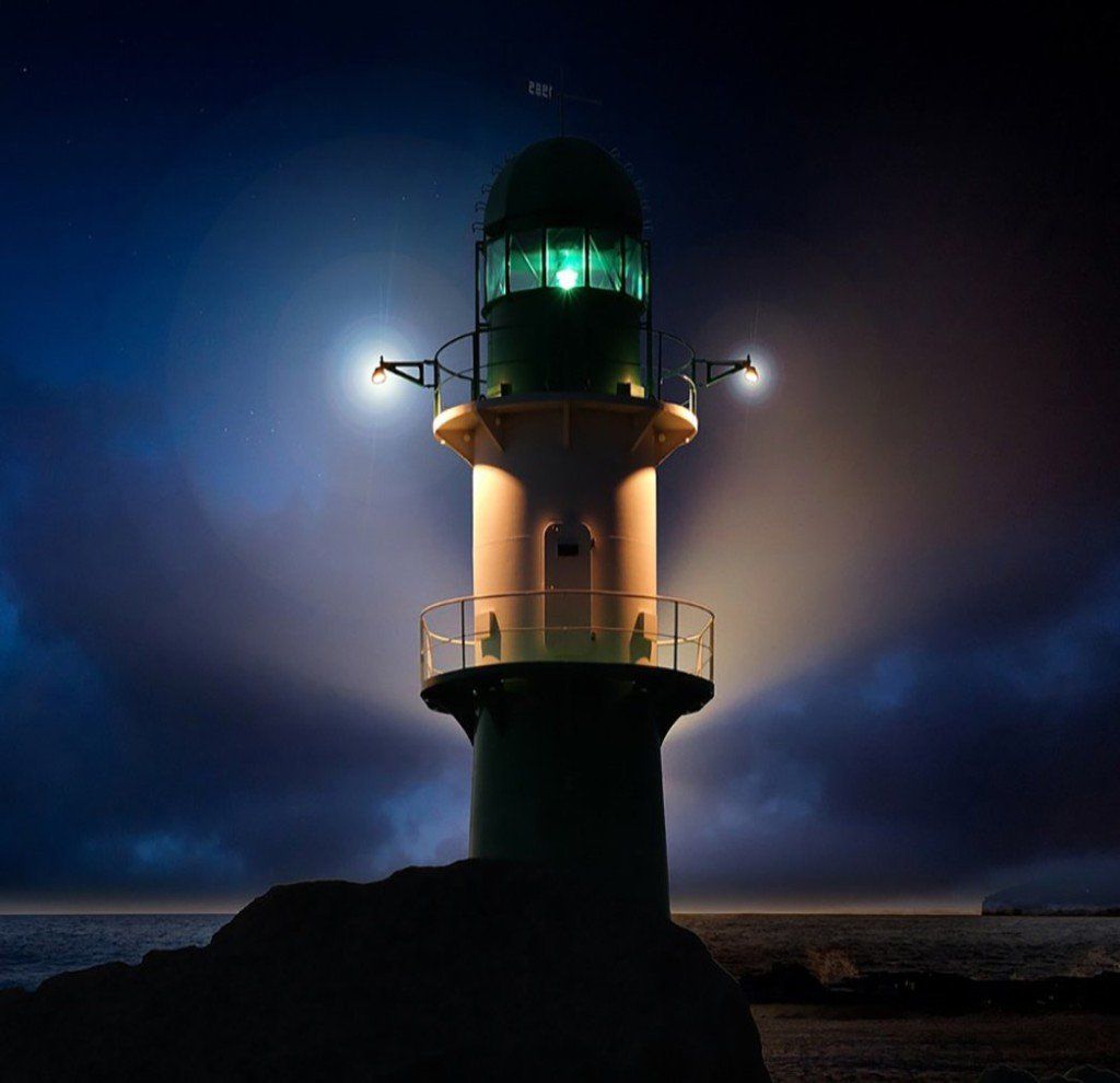 A lighthouse that is lit up at night