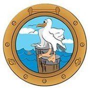 A seagull is sitting on a dock in a porthole.
