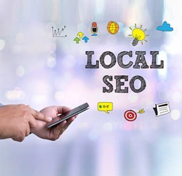 A person is holding a cell phone with the words `` local seo '' written on it.