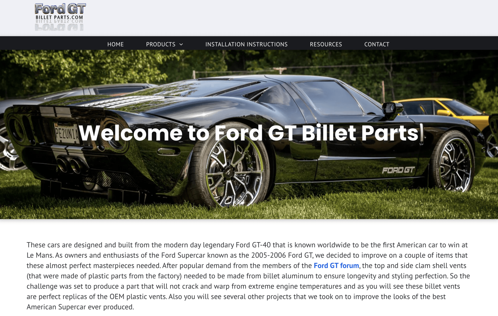 A black ford gt billet parts car is parked in the grass.