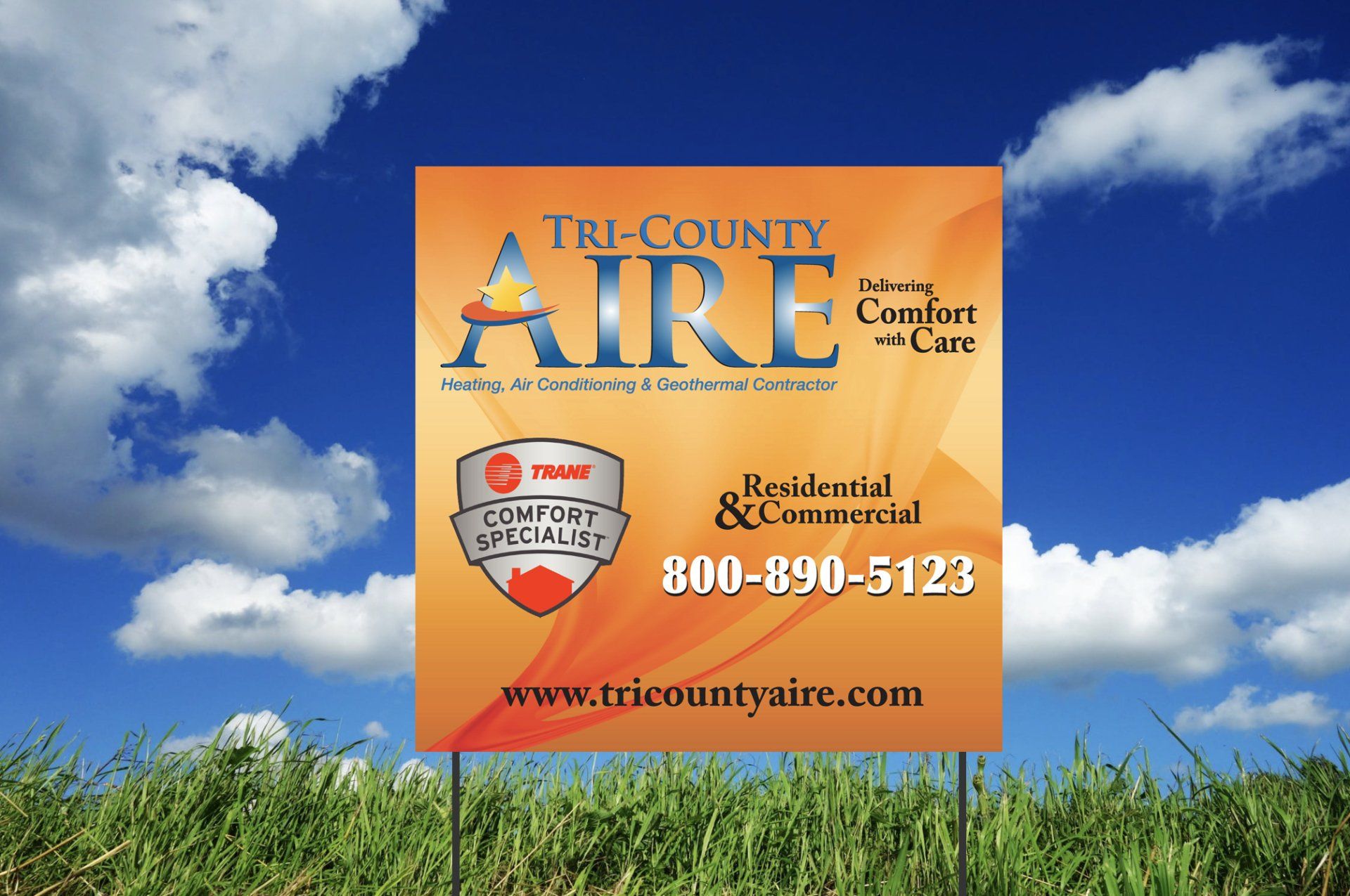 A sign for tri-county aire is in the middle of a grassy field