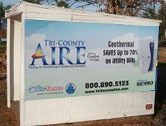 A white trailer with a sign on it that says `` tri-county aire ''.