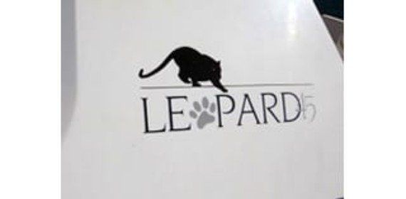 A white sign with a leopard on it