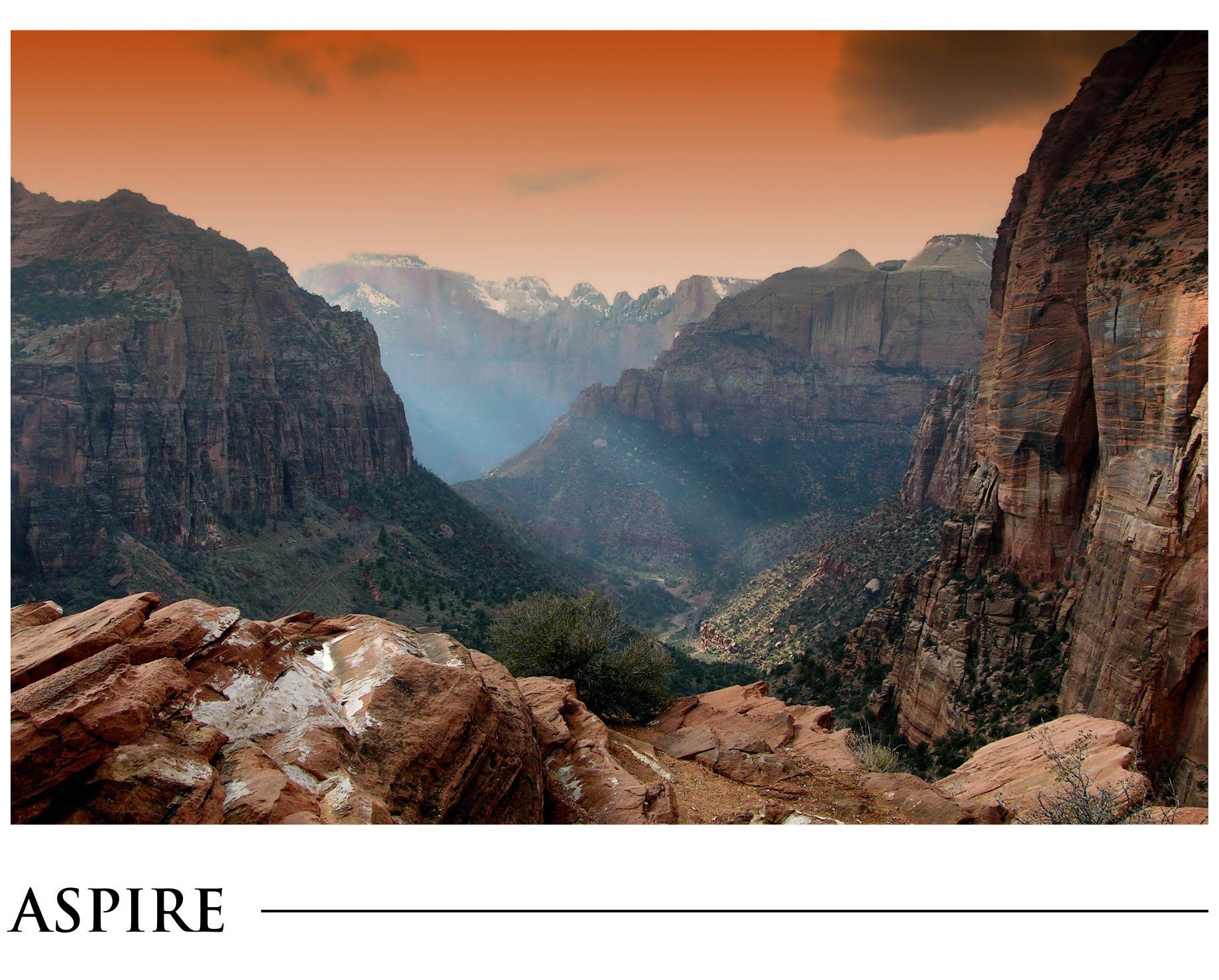 A picture of a mountain range with the word aspire on the bottom