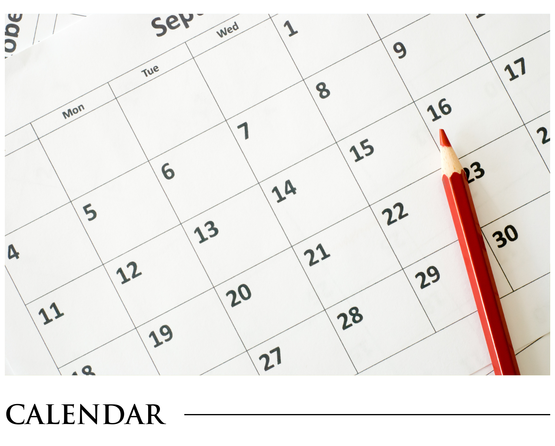 A calendar with a red pencil on it