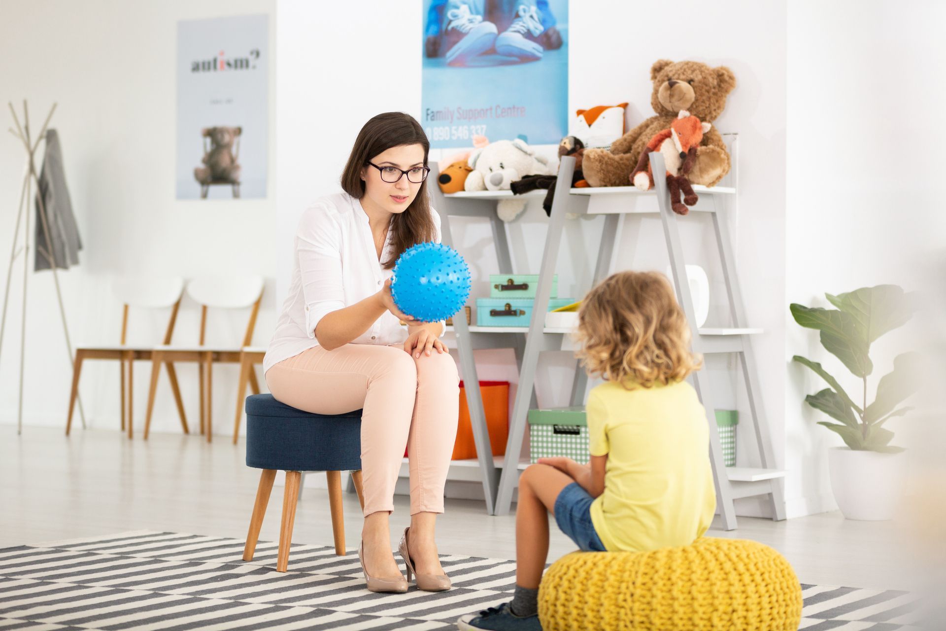 Woman is Holding a Blue Ball and Talking to a Child - Pendleton, IN - Assent Therapy ABA