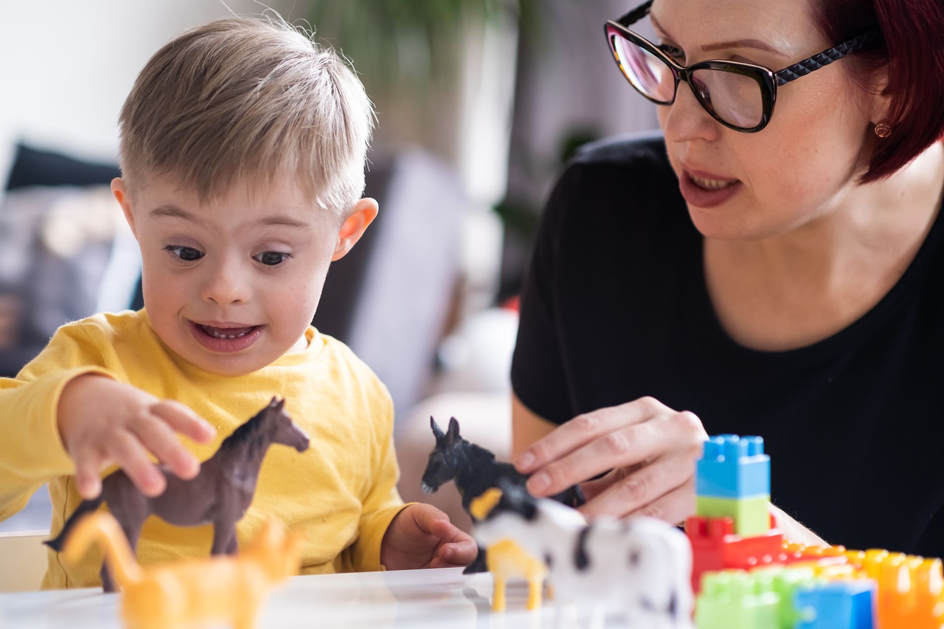 A Woman is Playing With a Child - Pendleton, IN - Assent Therapy ABA