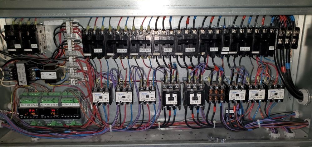 White rectangular air vent on a white textured ceiling.