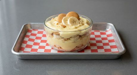 A chalkboard with the words image coming soon written on it