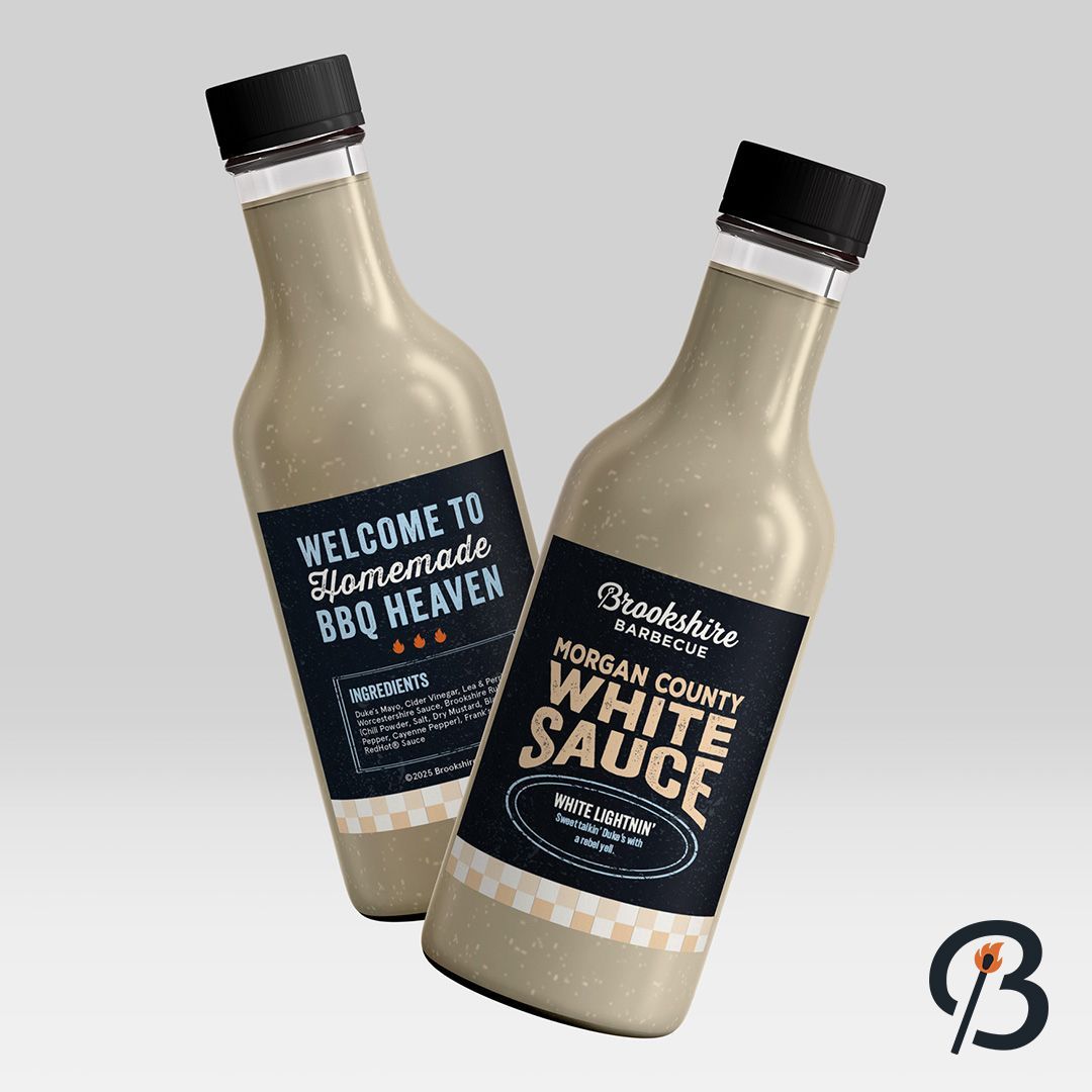 Two bottles of white BBQ sauce with black labels.
