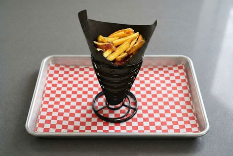 A bowl of potatoes next to a bowl of french fries.