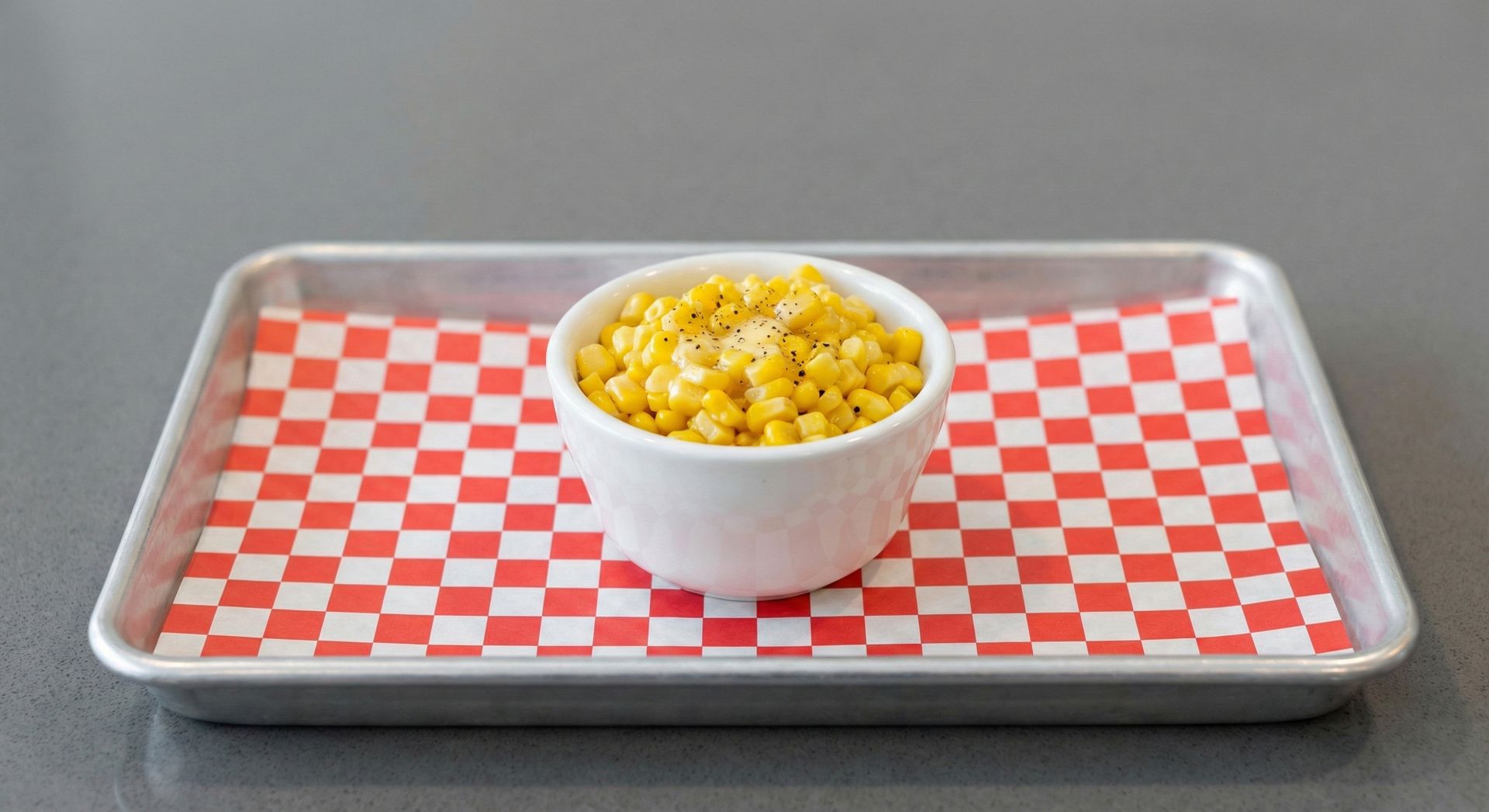 A bowl of potatoes next to a bowl of french fries.