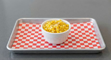A bowl of potatoes next to a bowl of french fries.