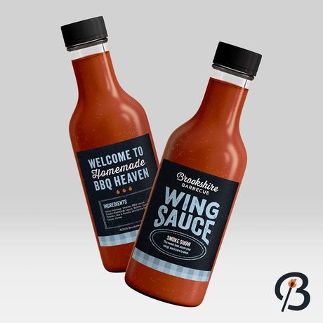 Two bottles of Brookshire BBQ Wing Sauce with black labels and red sauce.