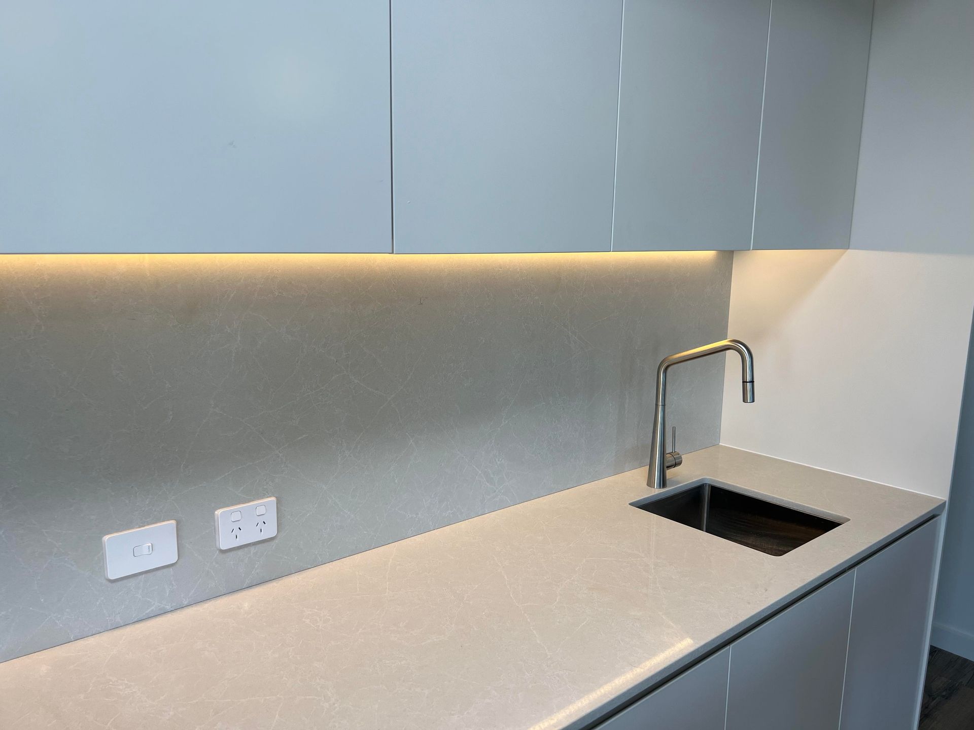 Kitchen counter with a sink and faucet, under-cabinet lighting — Col Groves Electrics Pty Ltd in Ballina, NSW