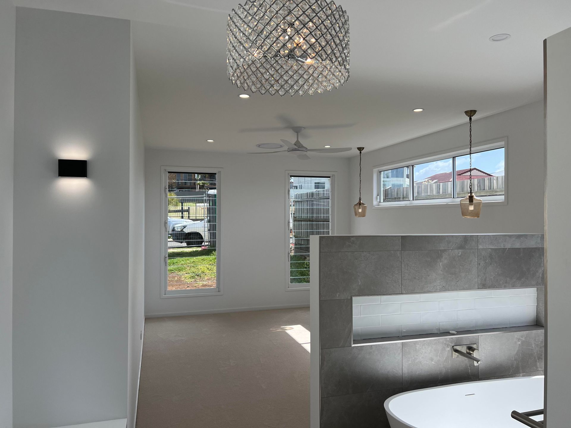 Bright white bedroom with large windows — Col Groves Electrics Pty Ltd in Ballina, NSW