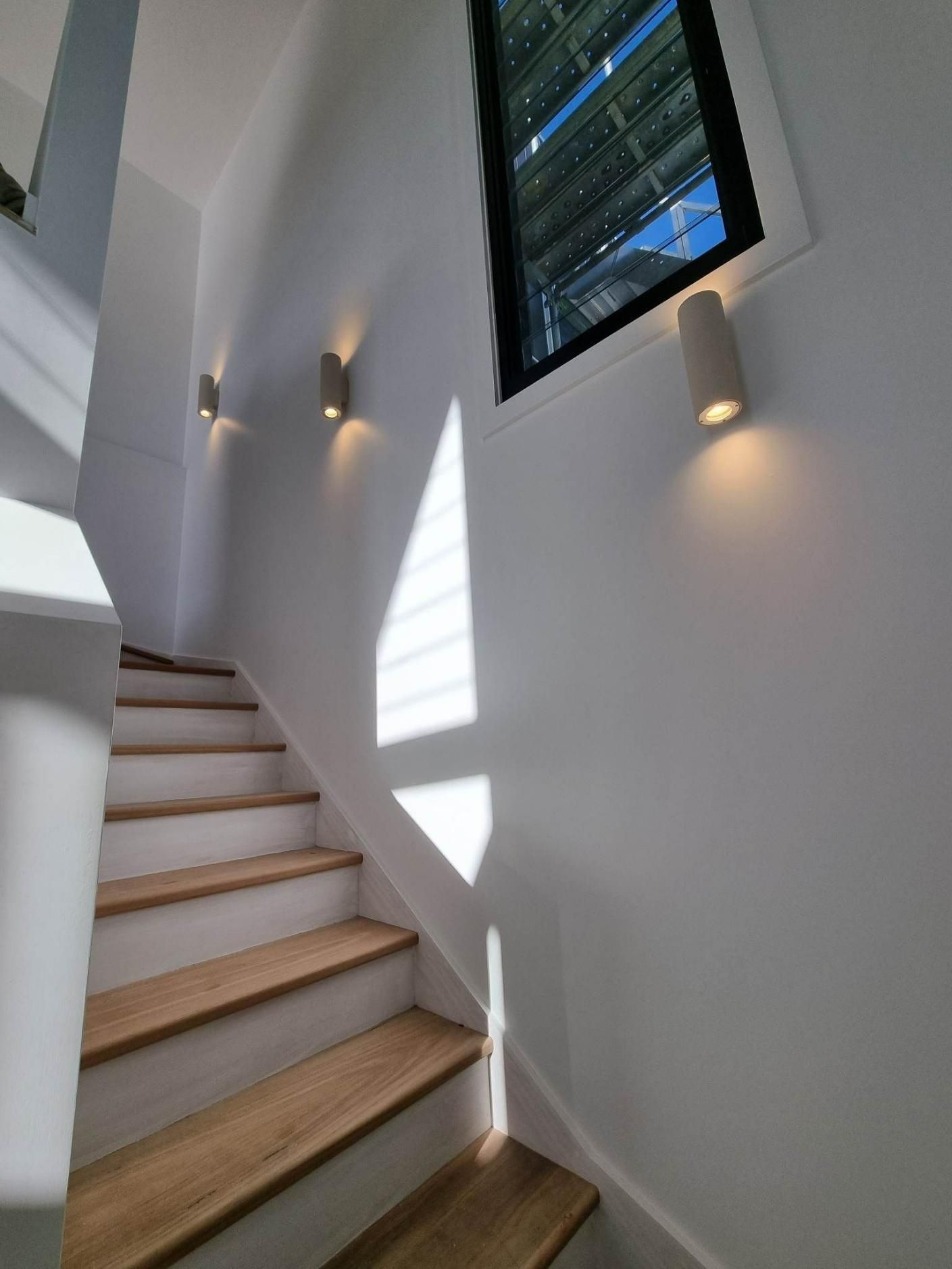 Staircase with wooden steps and white walls — Col Groves Electrics Pty Ltd in Ballina, NSW