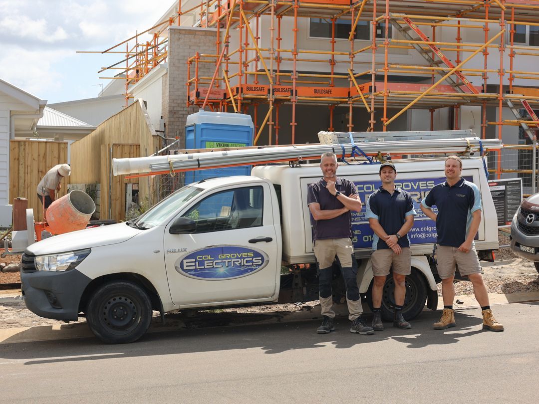 Three Men Stand Next to Their White Vehicle — Col Groves Electrics Pty Ltd in Ballina, NSW