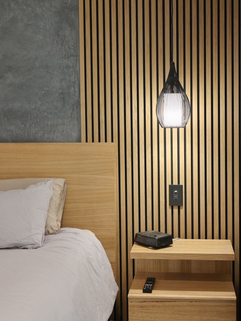 Bedroom with wooden headboard — Col Groves Electrics Pty Ltd in Ballina, NSW