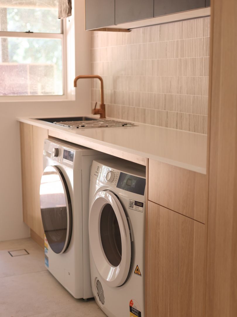 Laundry room with a washing machine and a dryer — Col Groves Electrics Pty Ltd in Ballina, NSW