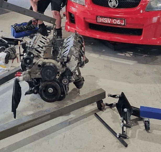 A Red Car With a License Plate — All Care Car Services Kumho Tyre Platinum Dealer in Kurri Kurri, NSW