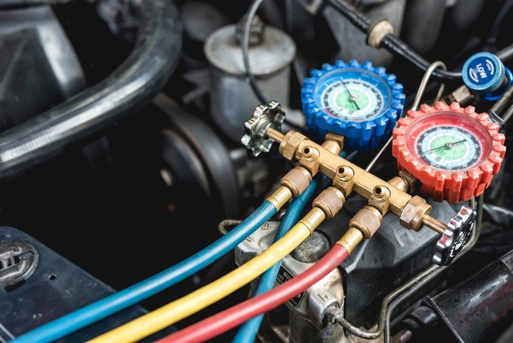 A Close Up of a Car Engine With Hose and Gauges — All Care Car Services Kumho Tyre Platinum Dealer in Kurri Kurri, NSW