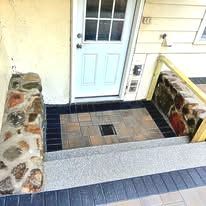 Stone retaining walls, new paver landing with drainage installed and granite steps leading to basement