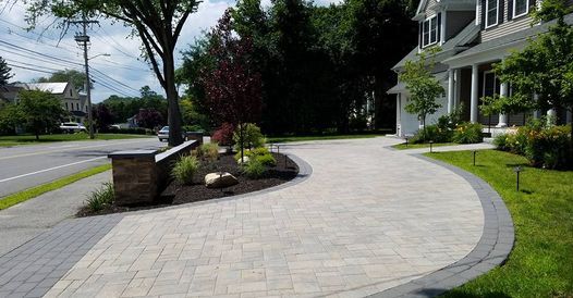 Paver driveway installation in Lexington, MA. Hardscaping paver driveway design, outdoor lighting, and retaining wall.