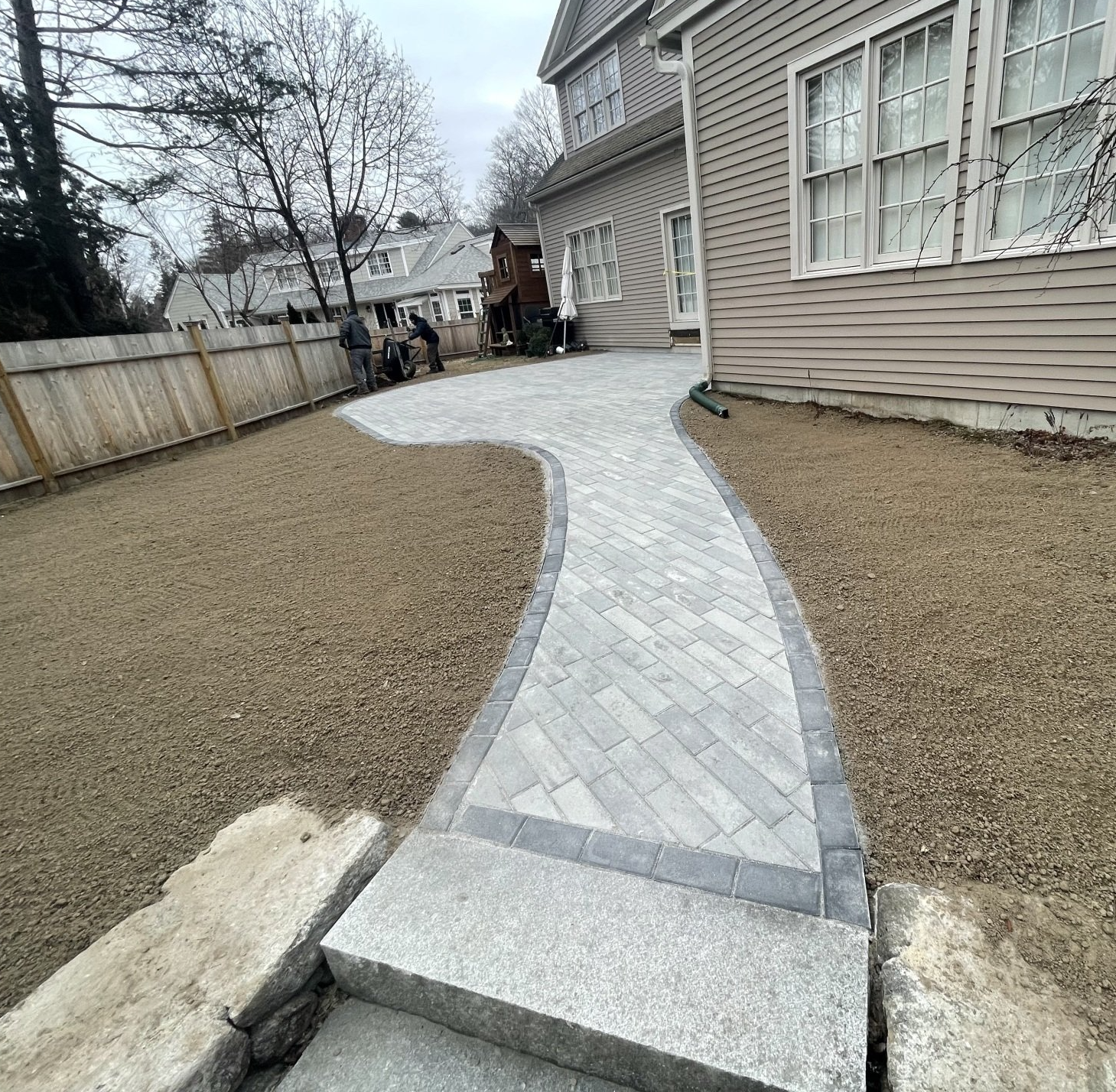 Paver patio and walkway in Lexington, MA. Granite step installation and outdoor patio project. 