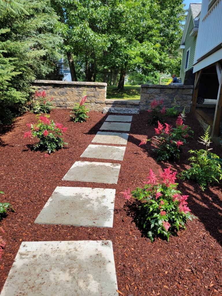 Landscape design. Mulch bed design, professional plant installation, stepping stones, patio, seating retaining wall.