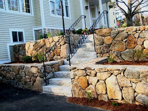 Large stone wall installation. Granite steps and stone wall design company in Lexington, MA.