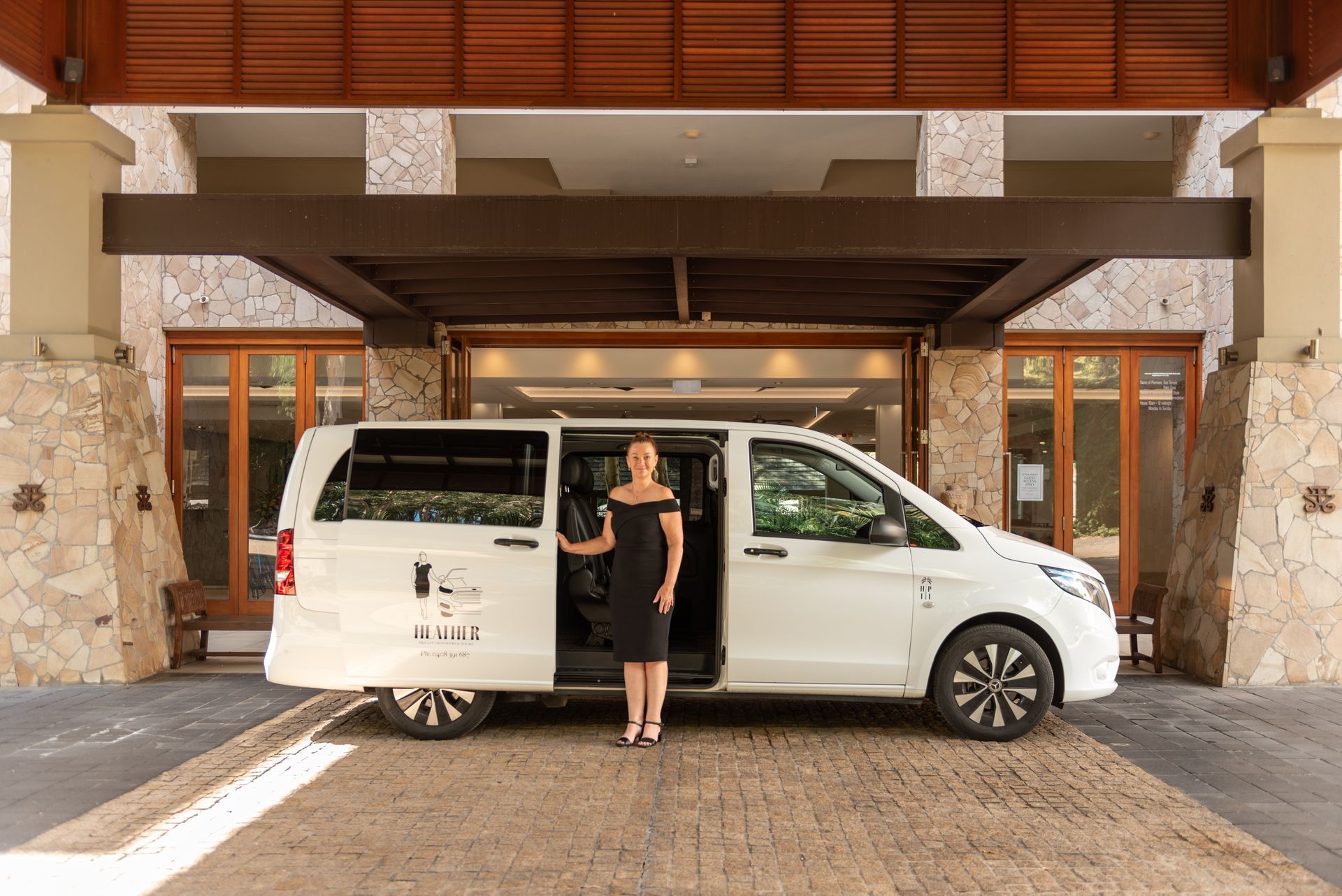 Heather outside of Pullman Sea Temple with her luxury Mercedes van