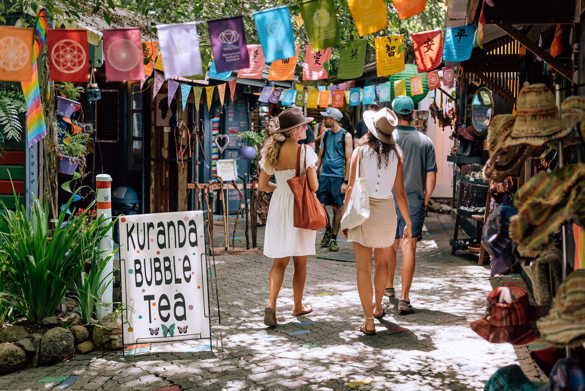 Travellers strolling through the Kuranda Village markets whilst on a tour