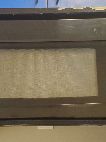 A microwave oven is sitting on top of a counter.