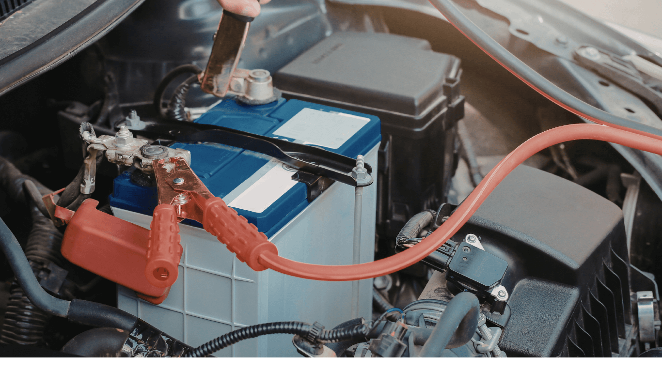 a mechanic jumping a car battery