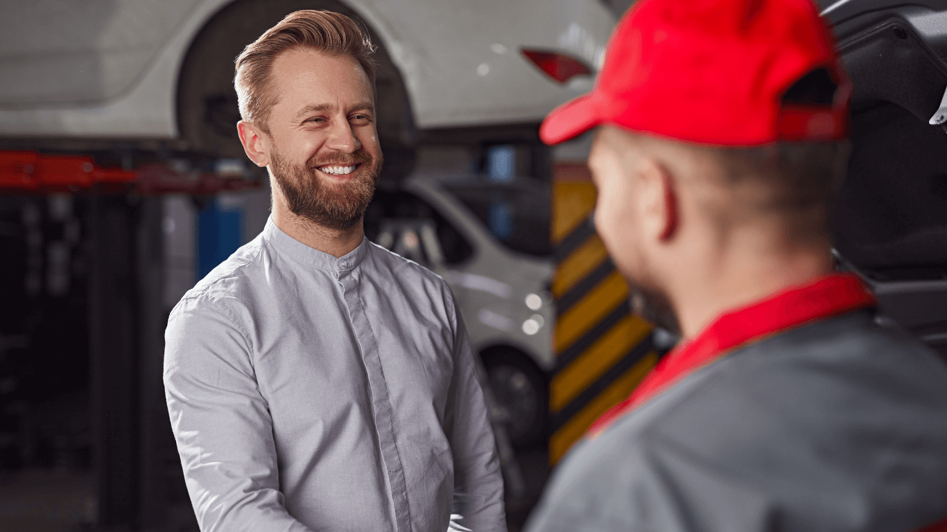 a happy customer shaking hands with his mechanic.