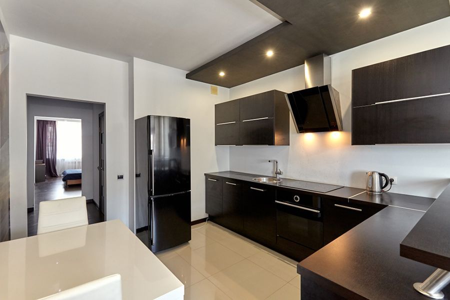 A Kitchen with Black Cabinets and A Black Refrigerator — Factory Seconds Coffs Harbour in Toormina, NSW