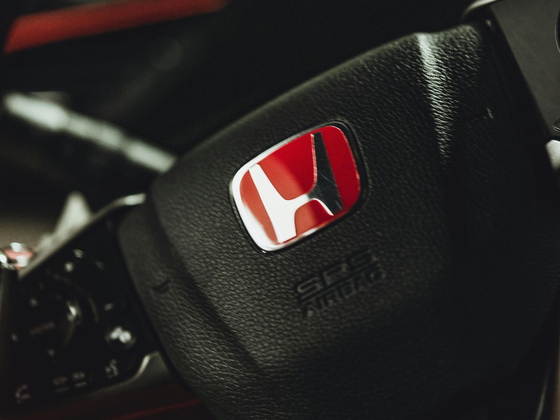 A close up of a honda steering wheel